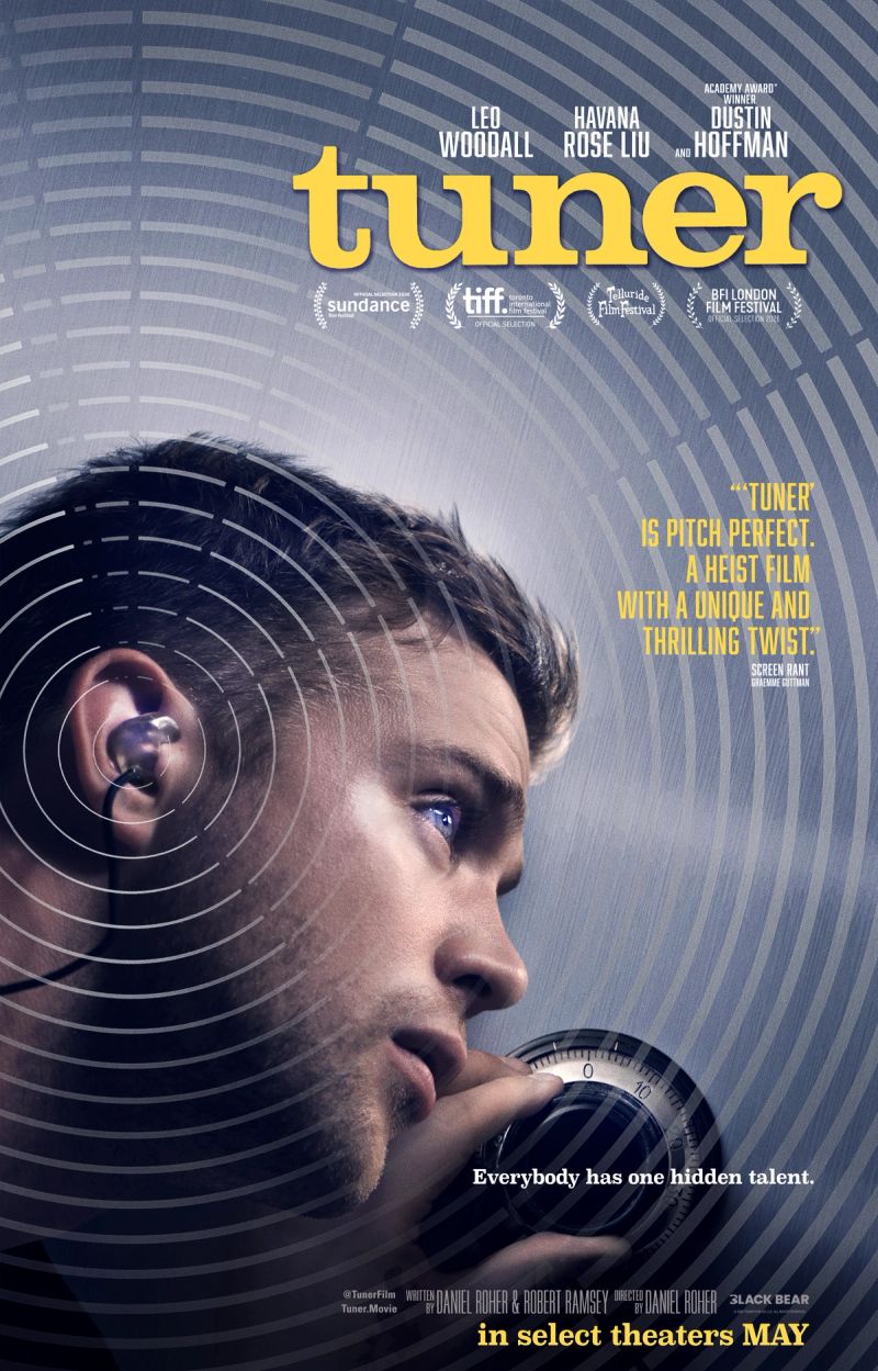 Tuner poster: Leo Woodall listening closely while turning the dial of a safe